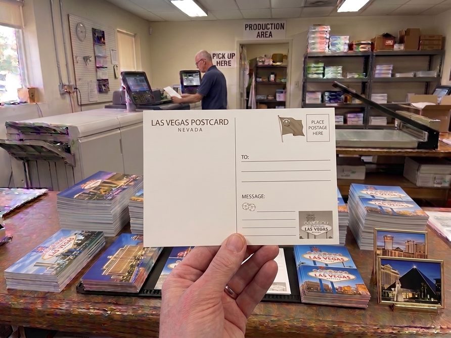 A printed Las Vegas postcard, ready for a mail drop